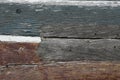 A close-up of the side of an old wooden rowing boat