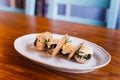 The close-up side photo of the food composition consisted of the mushrooms, cheese and dried bread.