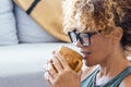 Close up side portrait of attractive blonde adult woman drinking coffee or tea at home alone smiling and enjoying the moment. Royalty Free Stock Photo