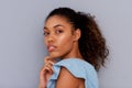 Side portrait of beautiful young african american woman against gray wall Royalty Free Stock Photo