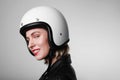 Close-up side portrait of happy biker young woman, wearing retro helmet, with red lips. Space for your text. Royalty Free Stock Photo