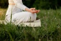 Close up side shot of chill meditation in nature. Sportsperson carefree relaxation yoga practice. Woman sitting caremat Royalty Free Stock Photo