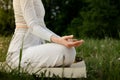 Close up side shot of chill meditation in nature. Sportsperson carefree relaxation yoga practice. Woman sitting caremat Royalty Free Stock Photo