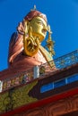 Close up at the side Statue of Guru Rinpoche, the patron saint of Sikkim that view at the base from front and below.