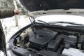 Close-up side view of auto mechanic man checking engine oil level in car, workshop, garage. car repairing service with Royalty Free Stock Photo