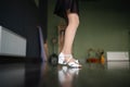 Close-up side view of child foots in dancing shoes on the floor in studio. Dance training class for kids. Girls athlete