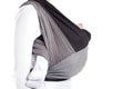 Close up side view of craddle position in front cross carry wrap in woven wrap baby carrier Royalty Free Stock Photo