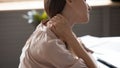 Close up view fatigued woman touches nape massaging tensed muscles Royalty Free Stock Photo