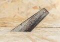 Close up side view of hand saw cutting wood plank Royalty Free Stock Photo