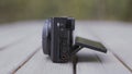 Close up side view of a modern professional shooting camera lying on a wooden bench. Action. Concept of shooting Royalty Free Stock Photo