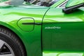 Close-up side view of new modern eco sportscar charging socket. Electric badge symbol on green metallic shiny car fender. Zero Royalty Free Stock Photo