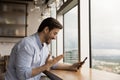 Close up overjoyed businessman wearing glasses looking at phone screen