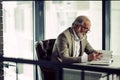 Close up side view photo of mature businessman working in the modern office Royalty Free Stock Photo