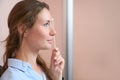 Charming woman is covering her one eye with frame in the optical clinic Royalty Free Stock Photo