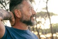 Close up side view portrait of happy adult man smiling and enjoying time in outdoor leisure activity with park background in Royalty Free Stock Photo