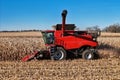 close up side view of a red harvester combining corn Royalty Free Stock Photo