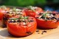 close-up, side view shot of half-cut grilled tomatoes, showing darkened insides