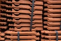 Close up and side view of stack of orange roofing tiles vibrant space for text texture Royalty Free Stock Photo