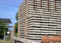 Close up side view of truck while load stack of prestressed concrete slabs for construction