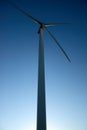 Close up, side view of a wind tower turbine electricity gererator, renewable energy source. Wind Farm with blue sky and Royalty Free Stock Photo