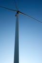 Close up, side view of a wind tower turbine electricity gererator, renewable energy source. Wind Farm with blue sky and Royalty Free Stock Photo