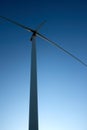 Close up, side view of a wind tower turbine electricity gererator, renewable energy source. Wind Farm with blue sky and Royalty Free Stock Photo