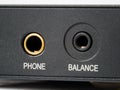 Close-up of the side wall of the audio player with gold-plated headphone jacks for unbalanced connection and for balanced Royalty Free Stock Photo