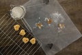 Sieve with icing sugar cookies on cooling rack Royalty Free Stock Photo