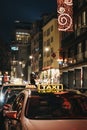 Close up of a sign on yellow taxi on a street in Vienna, Austria, at night