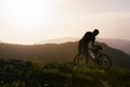 Close up silhouette of an athlete mountain biker riding his bike on rocky mountains Royalty Free Stock Photo