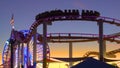 SILHOUETTE: Beautiful view of the amusement park on Santa Monica Pier at sunset. Royalty Free Stock Photo