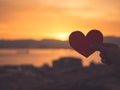 Close up and Silhouette of hand holding red heart during sunset Royalty Free Stock Photo