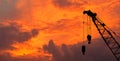 Close-up silhouette industrial big crane with steel hook for work on construction building Royalty Free Stock Photo