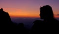 CLOSE UP: Young female hiker observes the Julian Alps from mountaintop at sunset