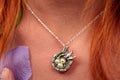 Close-up silver bird necklace