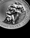 Close up of Silver Bullion Coin on a black mirror background