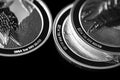 Close up of Silver Bullion Coin on a black mirror background