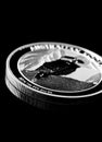 Close up of Silver Bullion Coin on a black mirror background