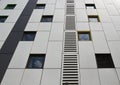 silver colored metal cladding panels on a modern building with repeating windows and geometric grid design Royalty Free Stock Photo