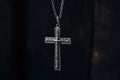 close-up of a silver crucifix pendant on a chain