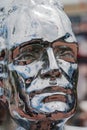 Close up of the silver face of a metal sculpture in an artisan m