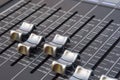 Close up of the silver faders of an audio mixer with gray background Royalty Free Stock Photo