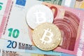 Close up of silver and golden Bitcoin on euro currency backgroun Royalty Free Stock Photo