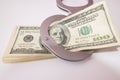 Close up of silver handcuffs and us dollars on white Royalty Free Stock Photo