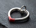 Close Up of Silver Heart Pendant with Red Enamel on Slate Background Royalty Free Stock Photo