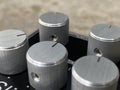 Close-up Silver metal knob and black control panel plate of boutique distortion Stomp box. Royalty Free Stock Photo