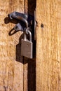 Close-up of silver metal lock on bolt of wood door to old buildi