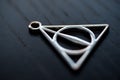 Close up silver necklace focus deathly hallows Royalty Free Stock Photo