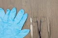 Close up silver scalpel surgical scissors and forceps beside blue latex glove Royalty Free Stock Photo