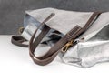 Close-up silver shiny beautiful leather bag with royal brown handles Royalty Free Stock Photo